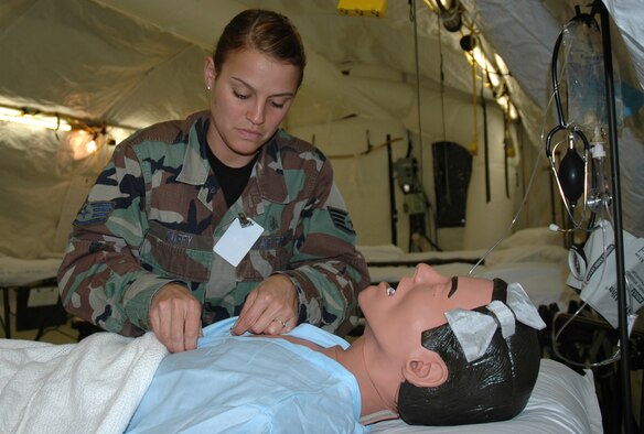 Staff Sgt. Melanie Duffy, a medical technician with the 88th Medical Group at Wright Patterson Air Force Base, Ohio, makes a "patient" comfortable in the Contingency Aeromedical Staging Facility during the Pacific Lifeline. In a wartime scenario, the CASF would treat wounded military personnel with injuries ranging from broken arms to severe trauma.  Pacific Lifeline is a humanitarian assistance disaster response exercise held at three different locations in the Hawaiian Islands and runs through Feb. 9. (U.S Air Force photo/Capt. Jennifer Gerhardt)