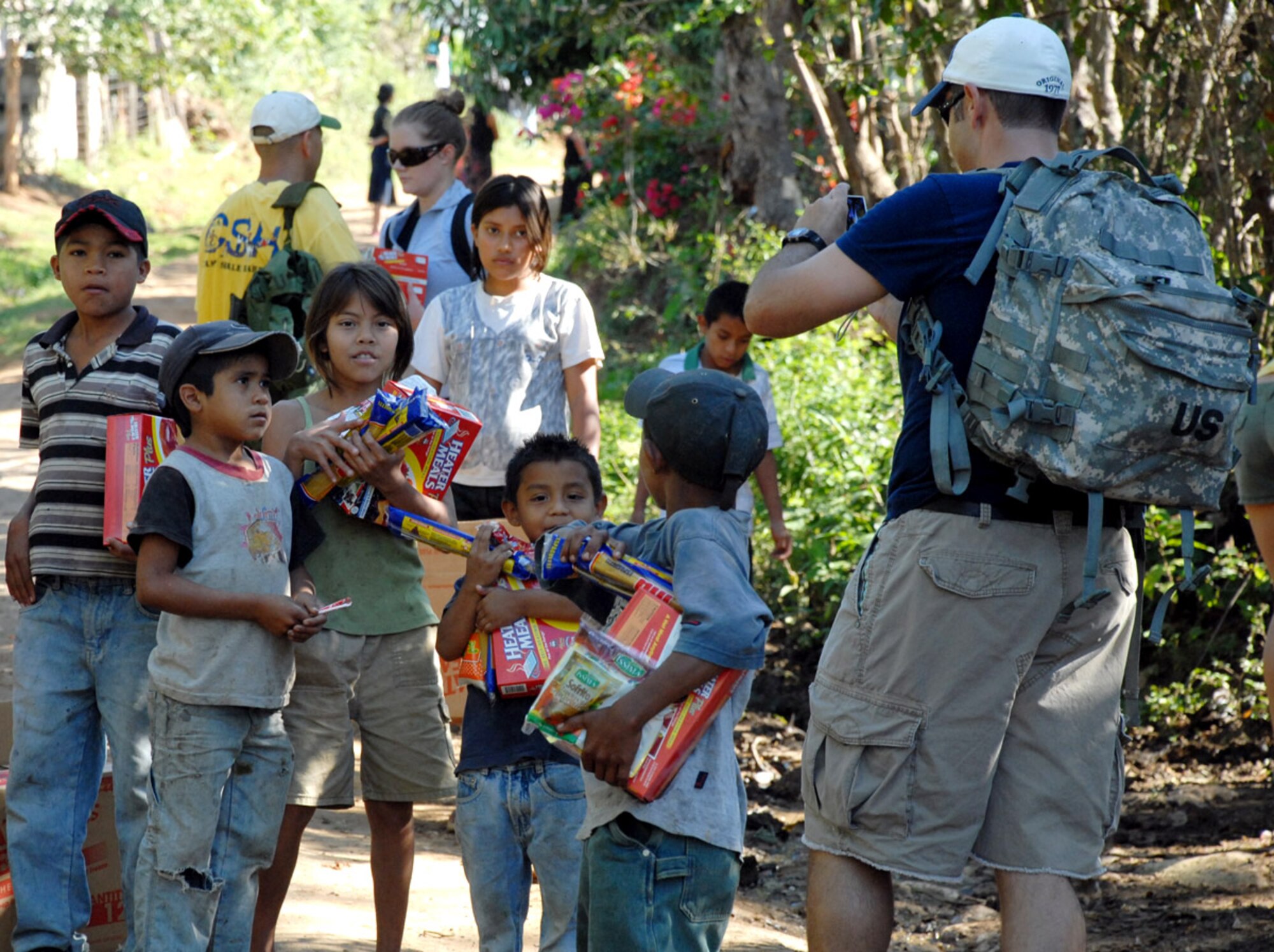 A member of Joint Task Force-Bravo takes a digital image of his new friends during a Feb. 2 hike into the mountains surrounding Comayagua, Honduras. More than 60 JTF-Bravo personnel deliverd more than 2,000 pounds of food to local Hondurans during a chapel hike which allows JTF-Bravo members the opportunity to see the countryside as well as interact with the locals. (U.S. Air Force photo/Tech. Sgt. William Farrow) 