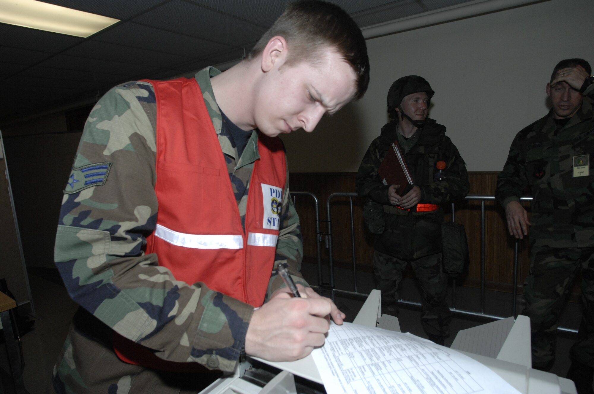 MOUNTAIN HOME AIR FORCE BASE, Idaho --Senior Airman James Kelley, 366th Aeromedical-Dental Squadron bioenvironmental engineering flight technician, reviews and processes deployment records in the personnel deployment function line during Exercise Sharpshooter 08-03 here, Feb. 3. The PDF line is the final check for deploying Airmen to ensure all paperwork is correct before deploying during the Phase 1 portion of the exercise. The 366th Fighter Wing conducts exercises to prepare personnel and equipment for the upcoming March 2008 Operational Readiness Inspection. (U.S. Air Force photo by Senior Airman Dana D. Hill) 