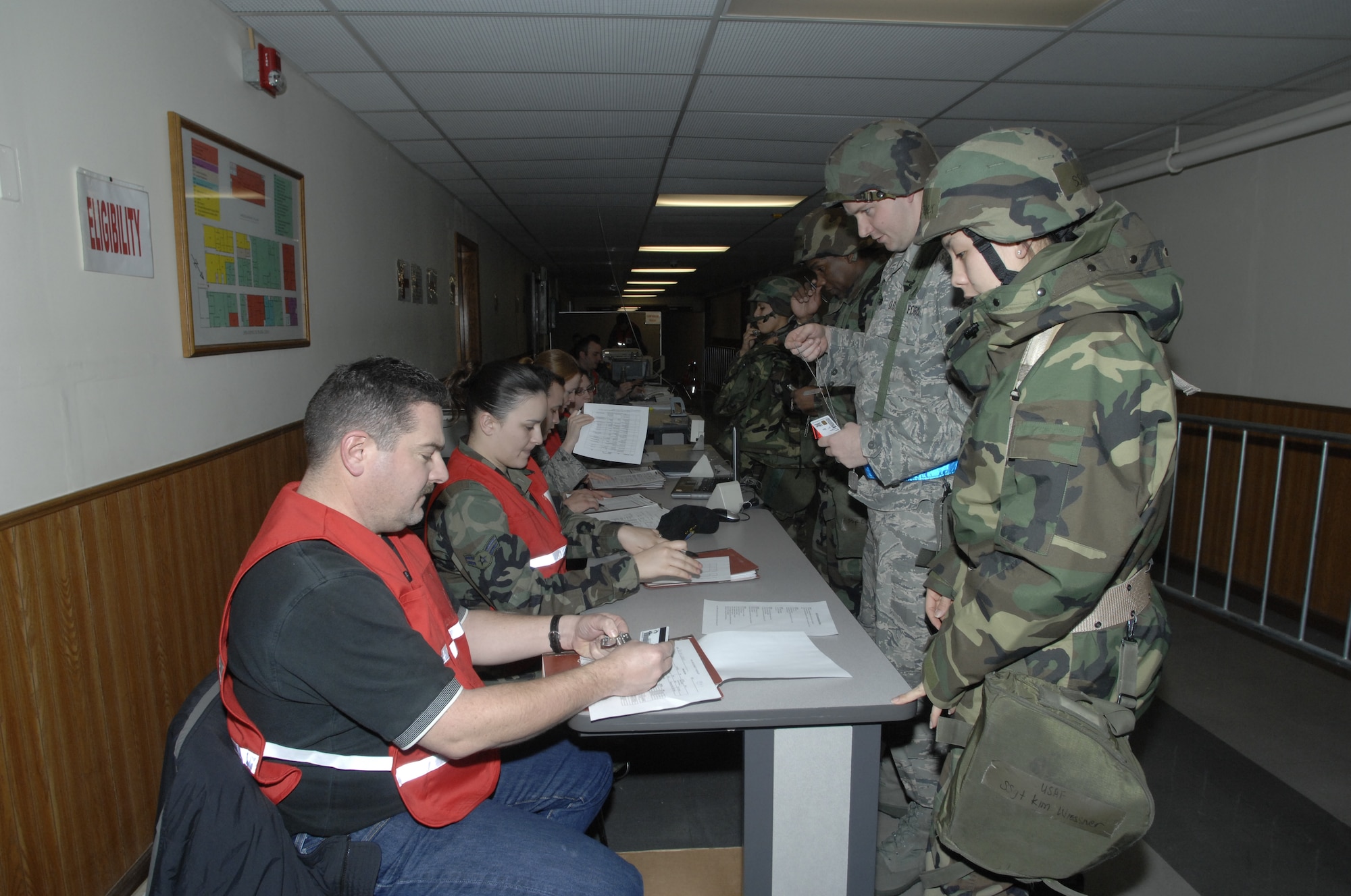MOUNTAIN HOME AIR FORCE BASE, Idaho -- Airmen from the 366th Fighter Wing process through the personnel deployment function line during Exercise Sharpshooter 08-03 here, Feb. 3. The PDF line is the final check for deploying Airmen to ensure all paperwork is correct before deploying during the Phase 1 portion of the exercise. The 366th Fighter Wing conducts exercises to prepare personnel and equipment for the upcoming March 2008 Operational Readiness Inspection. (U.S. Air Force photo by Senior Airman Dana D. Hill) 
