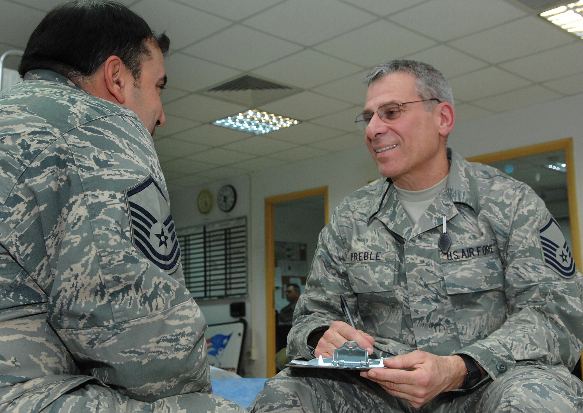 BALAD AIR BASE, Iraq -- Master Sgt. Robert Preble, deployed with the 439th Aeromedical Staging Squadron, talks with a fellow Airman. Sergeant Preble is a mental health technician deployed from Westover Air Reserve Base, Mass.