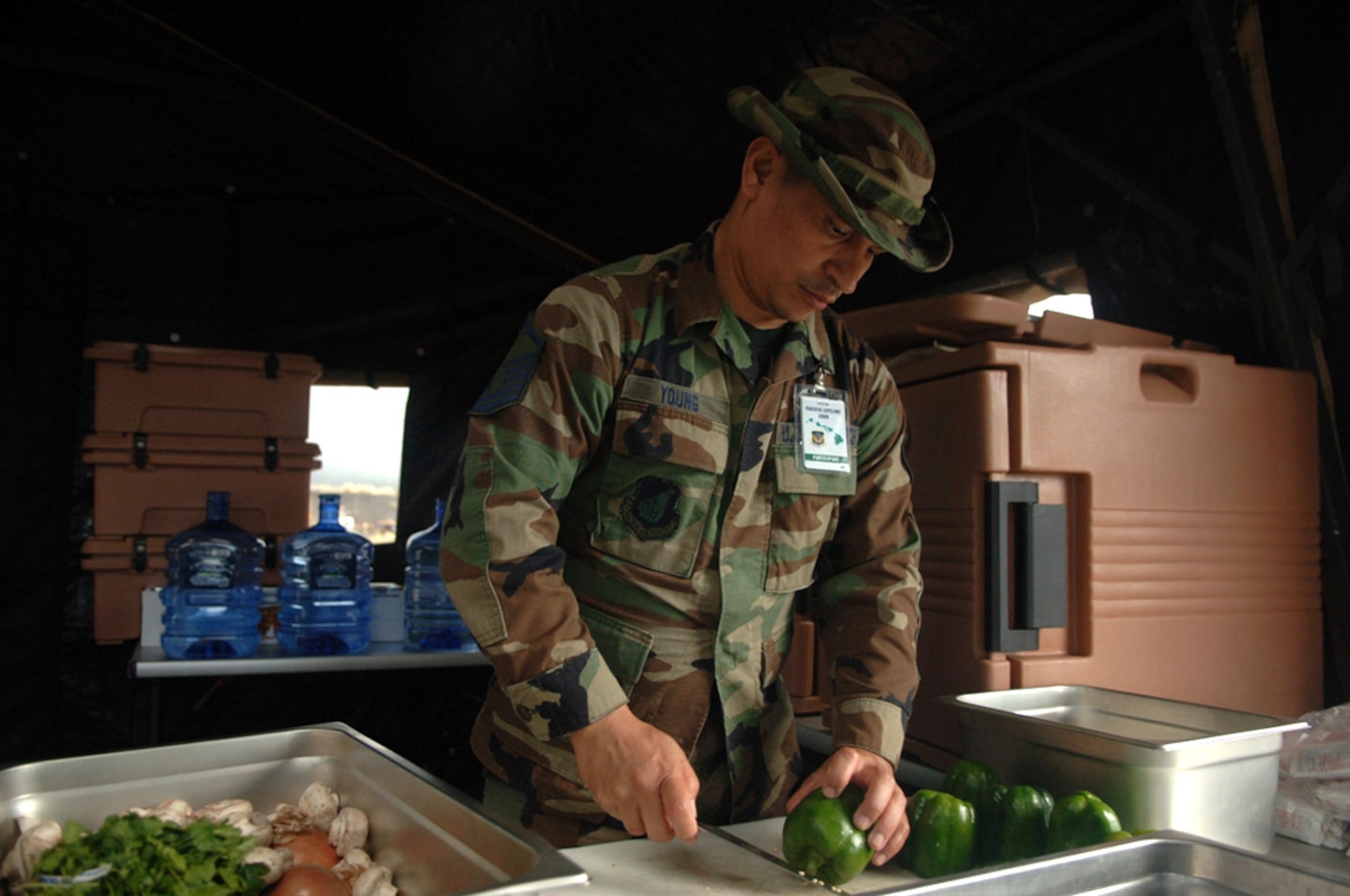 Master Sgt. Brunson Young prepares fresh vegetables Jan. 31 for an evening meal during the Pacific Air Forces total force humanitarian assistance and disaster relief exercise at the Kona International Airport in Hawaii. Sergeant Young is the services nightshift leader for the Pacific Lifeline exercise. Sergeant Young is with 154th Wing at Hickam Air Force Base, Hawaii. (U.S. Air Force photo/Staff Sgt. Patrick Mitchell) 