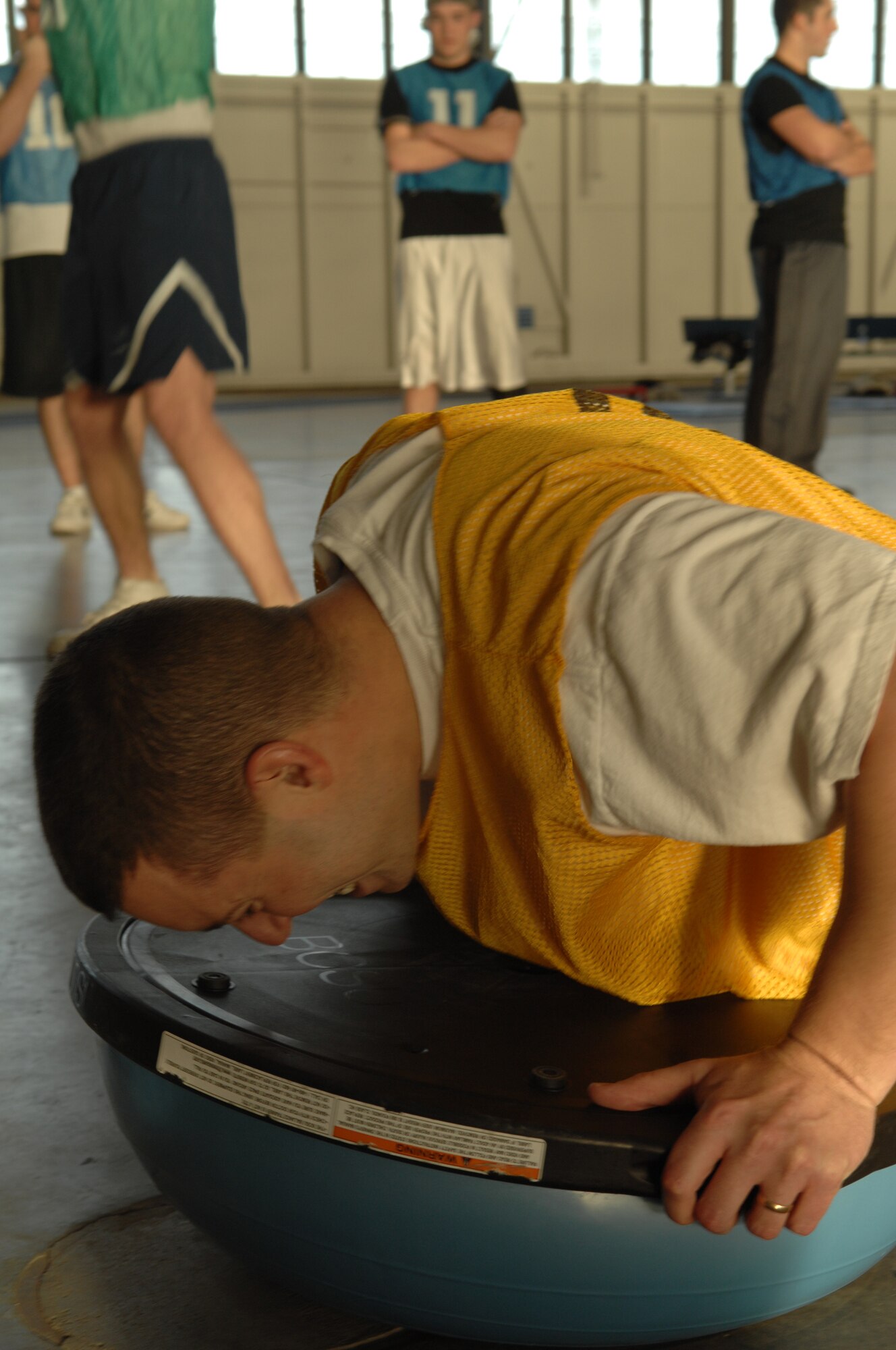 Capt. Michael Beaudet, 28th Communications Squadron, 28th Bomb Wing, struggles with push-ups after completing sit-ups during the Iron Flight competition, Jan. 31.  Four squadrons participated in the event; Communications, Logistics Readiness, Services, and the Air Force Financial Services Center.  (U.S. Air Force photo/Senior Airman Anthony Sanchelli)