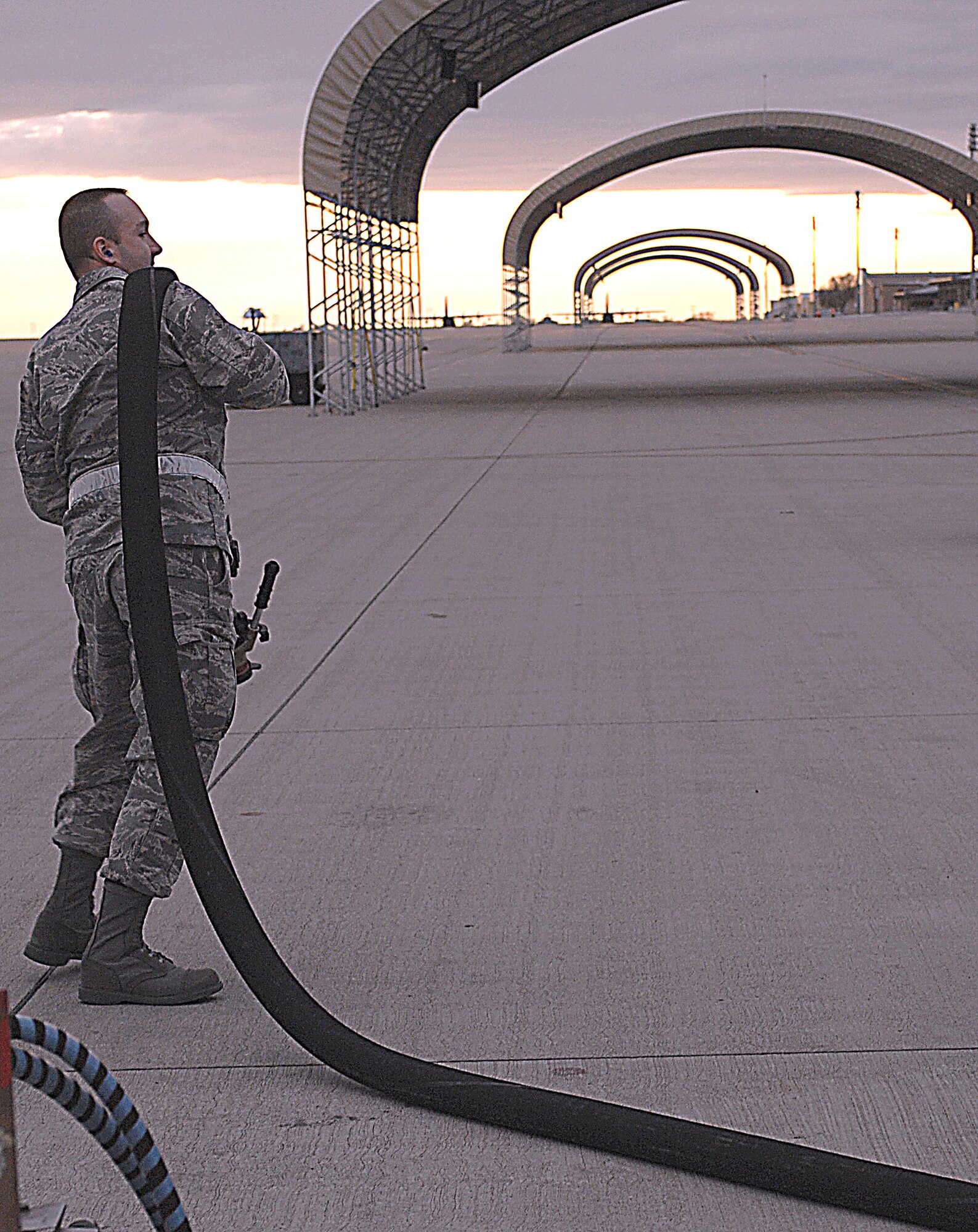 CANNON AIR FORCE BASE, N.M. -- Capt Jonathan Whittaker, s7th Special Operations Mission Support Group executive officer,  extends the fuel hose to begin a refueling operations. As an enlisted Airman, Captain Whittaker fueled one of the first F-16s that arrived here in 1995. On Jan. 30, he fueled the last. The final two jets then left for Spangdahlem Air Base, Germany. (Air Force photo by Airman 1st Class James Bell)