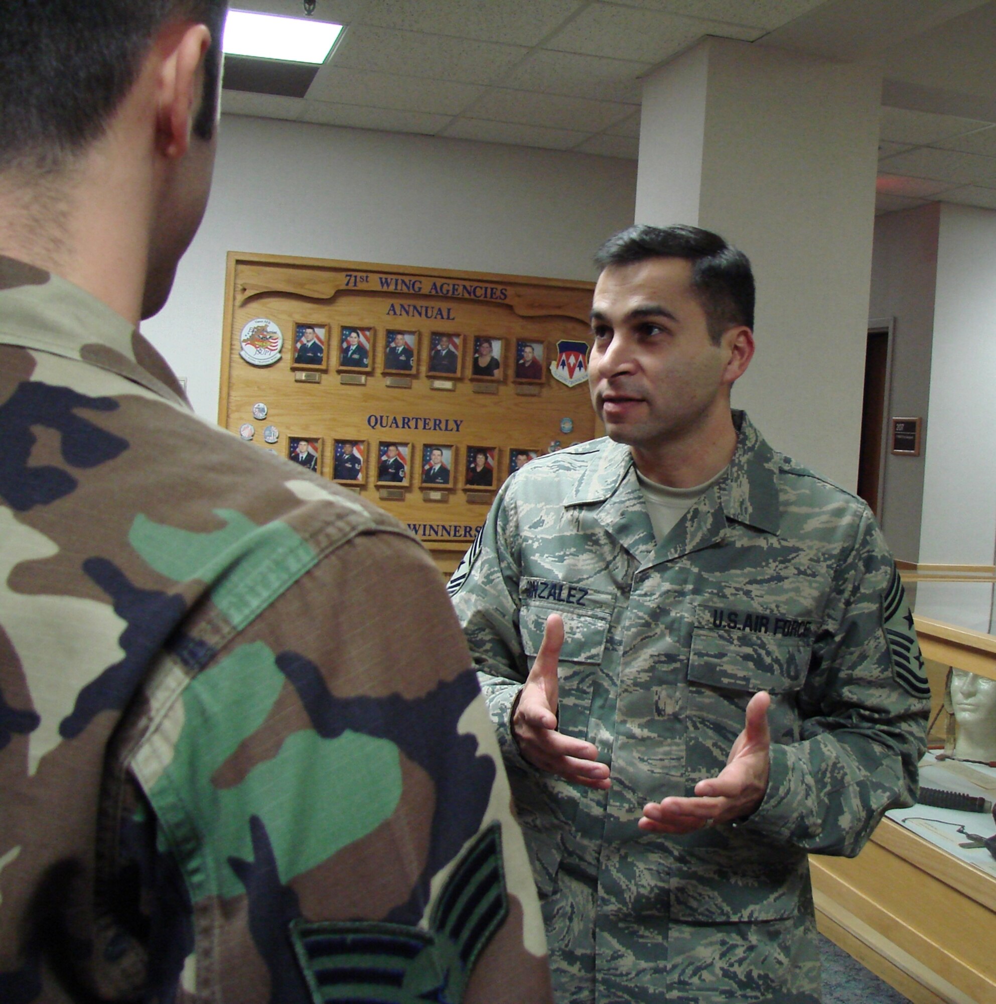 71st Flying Training Wing Command Chief Master Sgt. Ruben Gonzalez speaks to a Team Vance Airman about the Airman's Creed Feb. 5.  The chief, a native of Eagle Pass, Texas, recently moved to Vance from Laughlin AFB, Texas.  (U.S. Air Force photo by Tech. Sgt. Mary Davis)