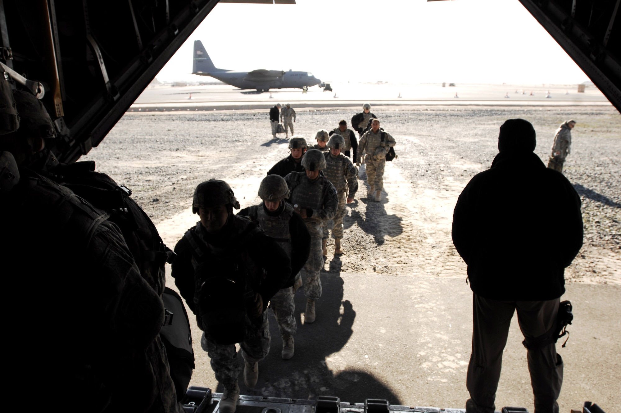 Soldiers enter a C-130H Hercules on Feb. 4, at an air base in the Southwest Asia. The Soldiers are heading to locations throughout the area of responsibility for Operation Iraqi Freedom. (U.S. Air Force photo/Staff Sgt. Patrick Dixon) 
