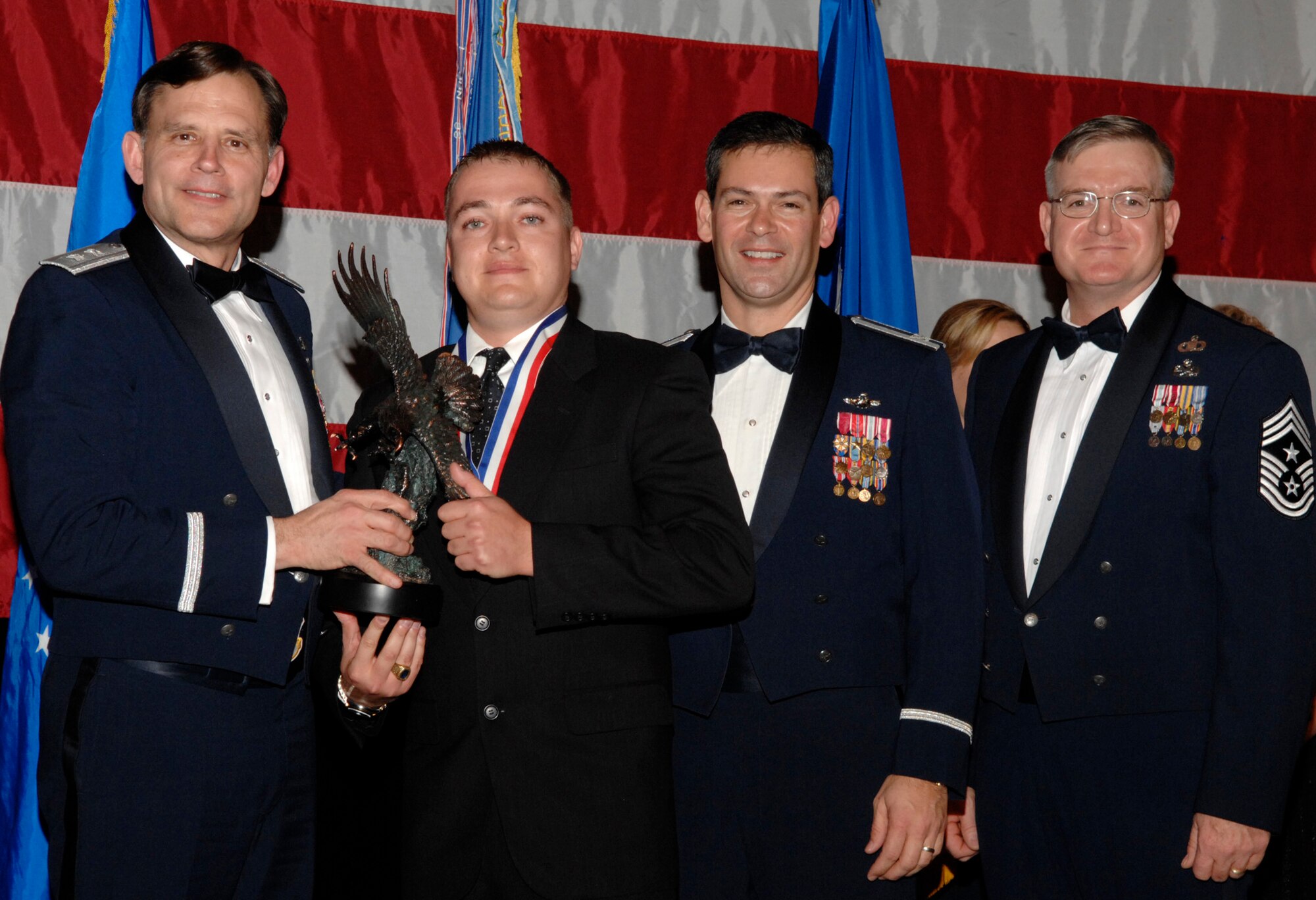 Jeno Nagy, 68th Electronic Warfare Squadron won the 53d Wing Category 4 Civilian of the Year Award during the annual awards banquet Jan. 31at the Emerald Coast Conference Center.  The night’s guest speaker and former 53d commander, Maj. Gen. (retired) Jack Catton (left) presented the awards. Col. Ken Wilsbach, 53d Wing commander, and Chief Master Sgt. Randy Salefske, 53d Wing command chief, also stand with the winner.  U.S. Air Force photo.