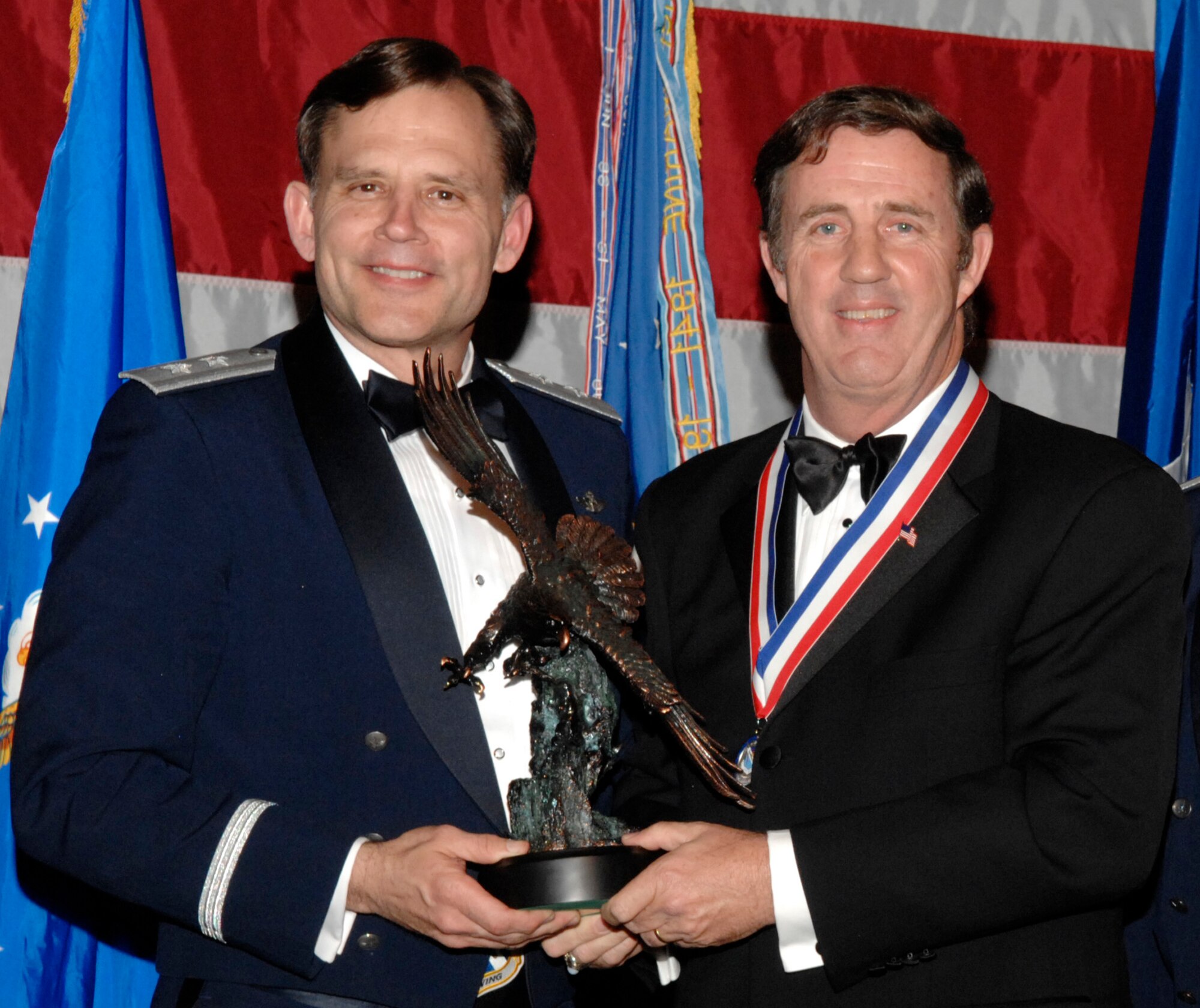Kevin Burns, 53d Test Management Group, won the 53d Wing Category 5 Civilian of the Year Award during the annual awards banquet Jan. 31at the Emerald Coast Conference Center.  The night’s guest speaker and former 53d commander, Maj. Gen. (retired) Jack Catton (left) presented the awards. U.S. Air Force photo.