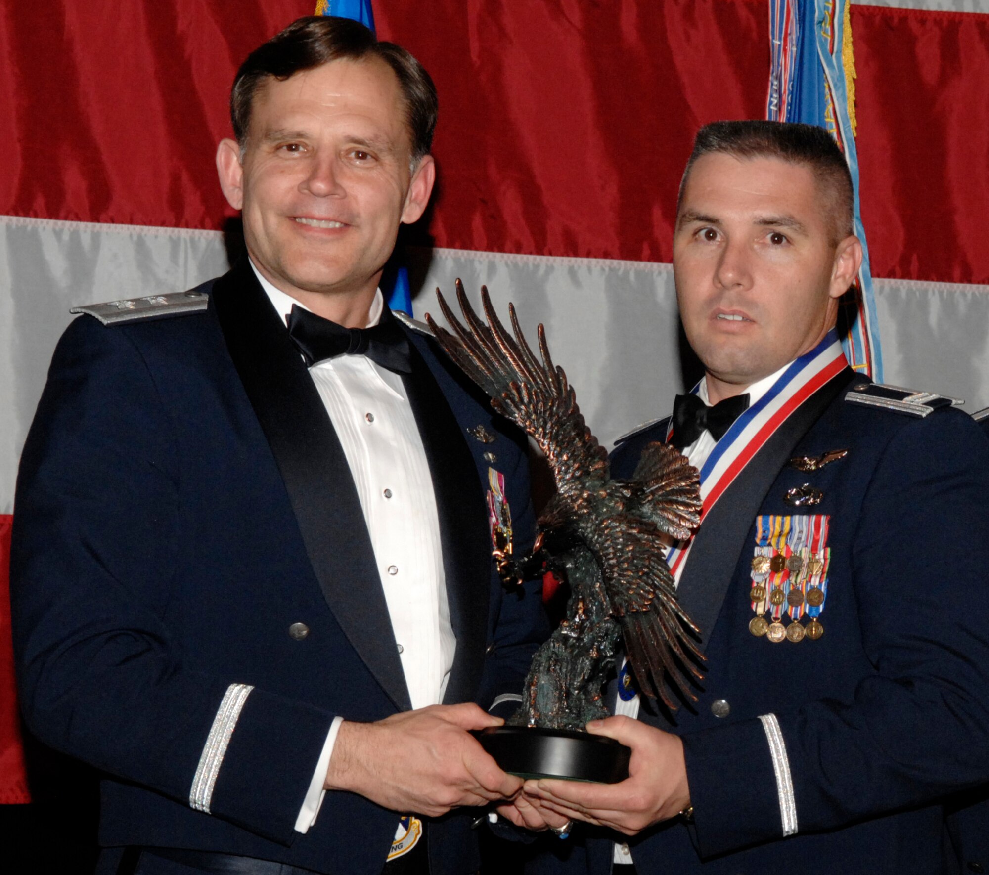 Capt. Ronnie Birge, 81st Range Control Squadron, won the 53d Wing Company Grade Officer of the Year Award during the annual awards banquet Jan. 31 at the Emerald Coast Conference Center.  The night’s guest speaker and former 53d commander, Maj. Gen. (retired) Jack Catton (left) presented the awards. U.S. Air Force photo.