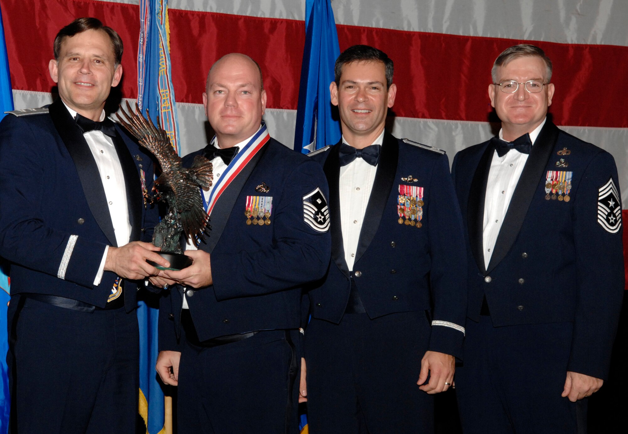 Master Sgt. Roy Grubbs won the 53d Wing First Sergeant of the Year Award during the annual awards banquet Jan. 31 at the Emerald Coast Conference Center.  The night’s guest speaker and former 53d commander, Maj. Gen. (retired) Jack Catton (left) presented the awards.  Col. Ken Wilsbach, 53d Wing commander, and Chief Master Sgt. Randy Salefske, 53d Wing command chief, also stand with the winner.  U.S. Air Force photo.