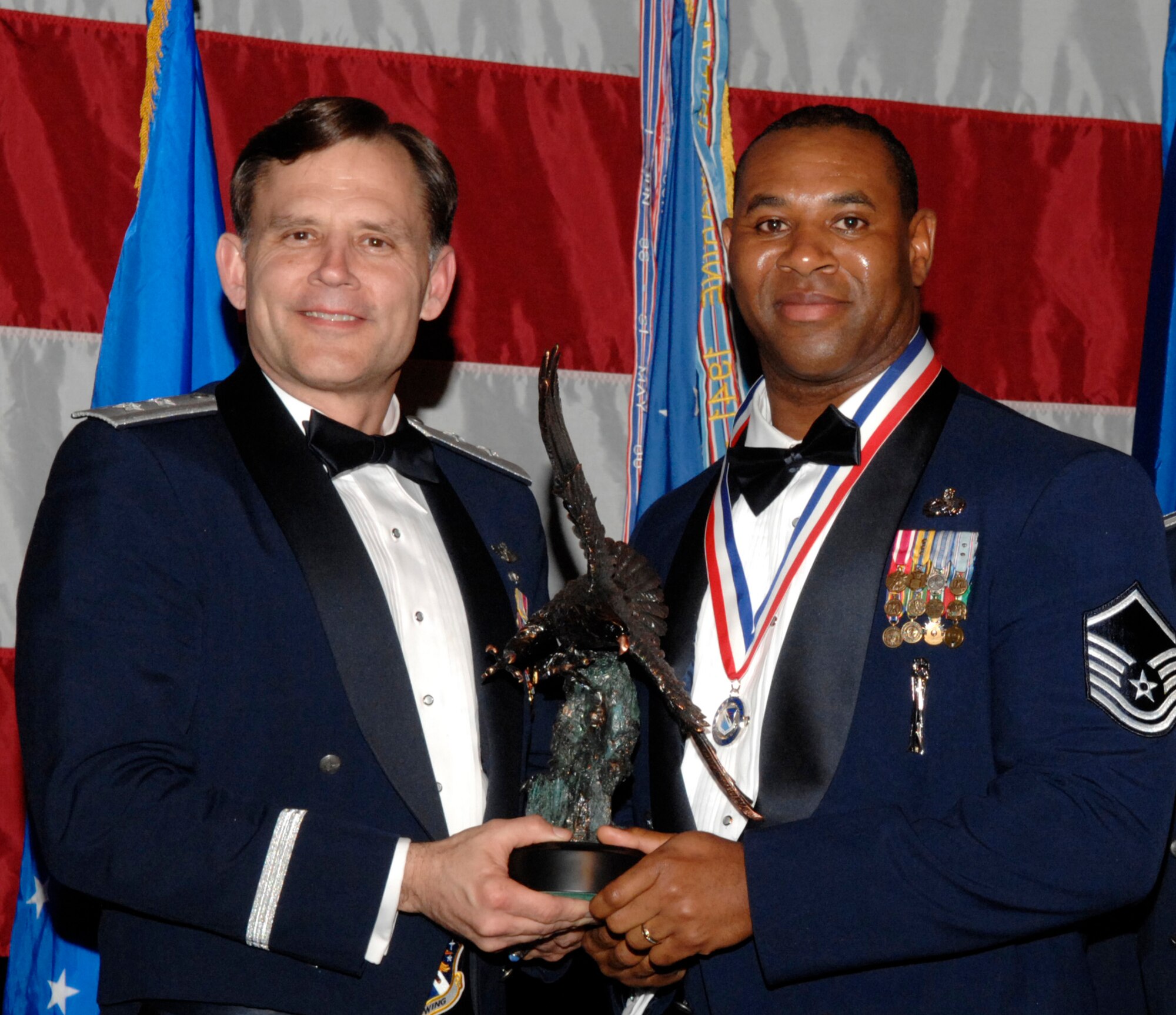 Master Sgt. Clay Slayton, 31st Test and Evaluation Squadron, won the 53d Wing Senior NCO of the Year Award during the annual awards banquet Jan. 31 at the Emerald Coast Conference Center.  The night’s guest speaker and former 53d commander, Maj. Gen. (retired) Jack Catton (left) presented the awards.  U.S. Air Force photo.