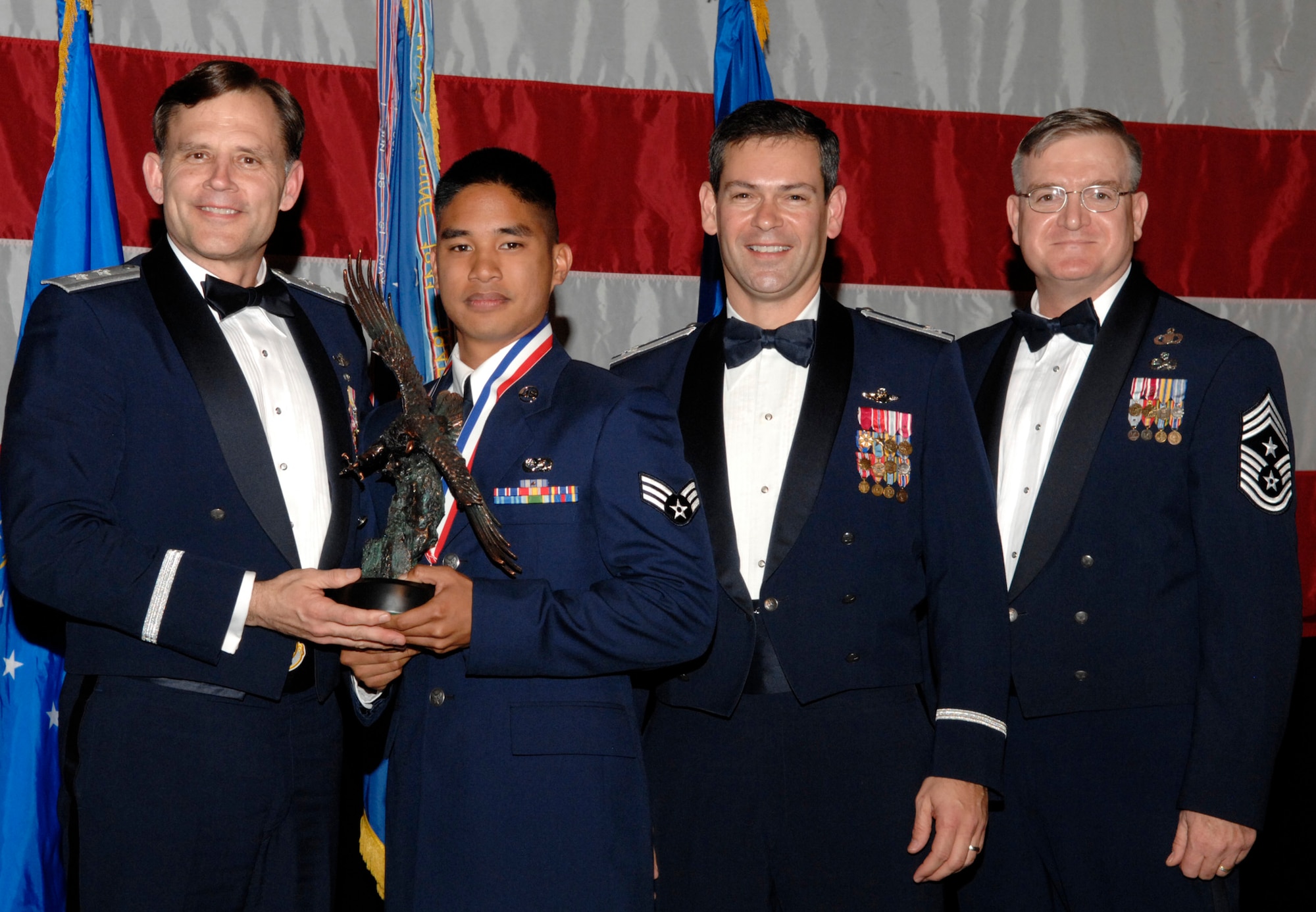 Senior Airman Allan Robillos, 16th Electronic Warfare Squadron, won the 53d Wing Airman of the Year Award  during the annual awards banquet Jan. 31 at the Emerald Coast Conference Center.  The night’s guest speaker and former 53d commander, Maj. Gen. (Retired) Jack Catton (left) presented the awards.  Col. Ken Wilsbach, 53d Wing commander, and Chief Master Sgt. Randy Salefske, 53d Wing command chief, also stand with the winner.  U.S. Air Force photo.