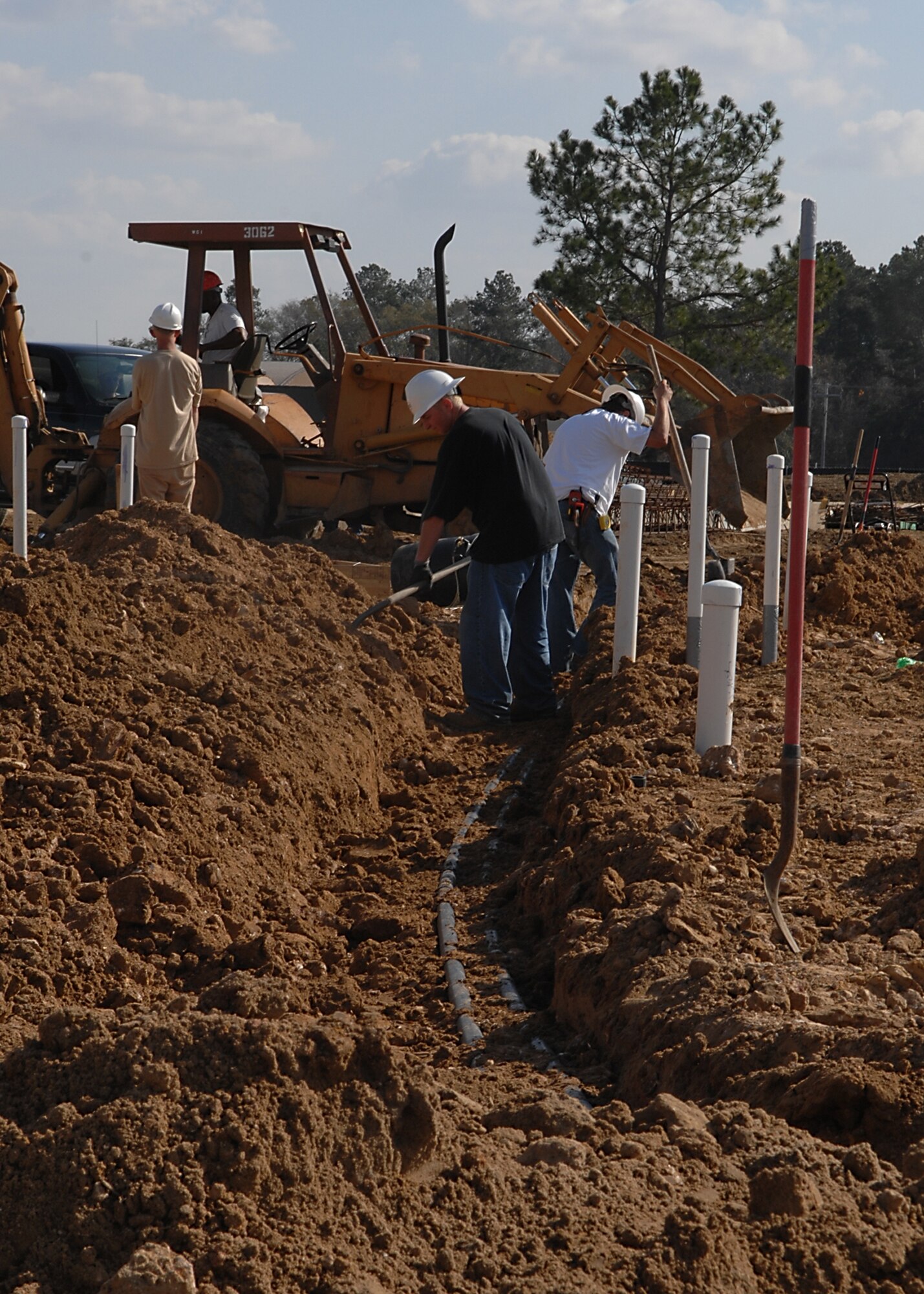MOODY AIR FORCE BASE, Ga. -- Contractors bury a utility line at the site of the new A-10C fuel cell facility here Feb. 4.  the building will enable maintainers to perform open cell maintenance on Moody-assigned A-10Cs (U.S. Air Force photo by Airman 1st Class Brittany Barker)