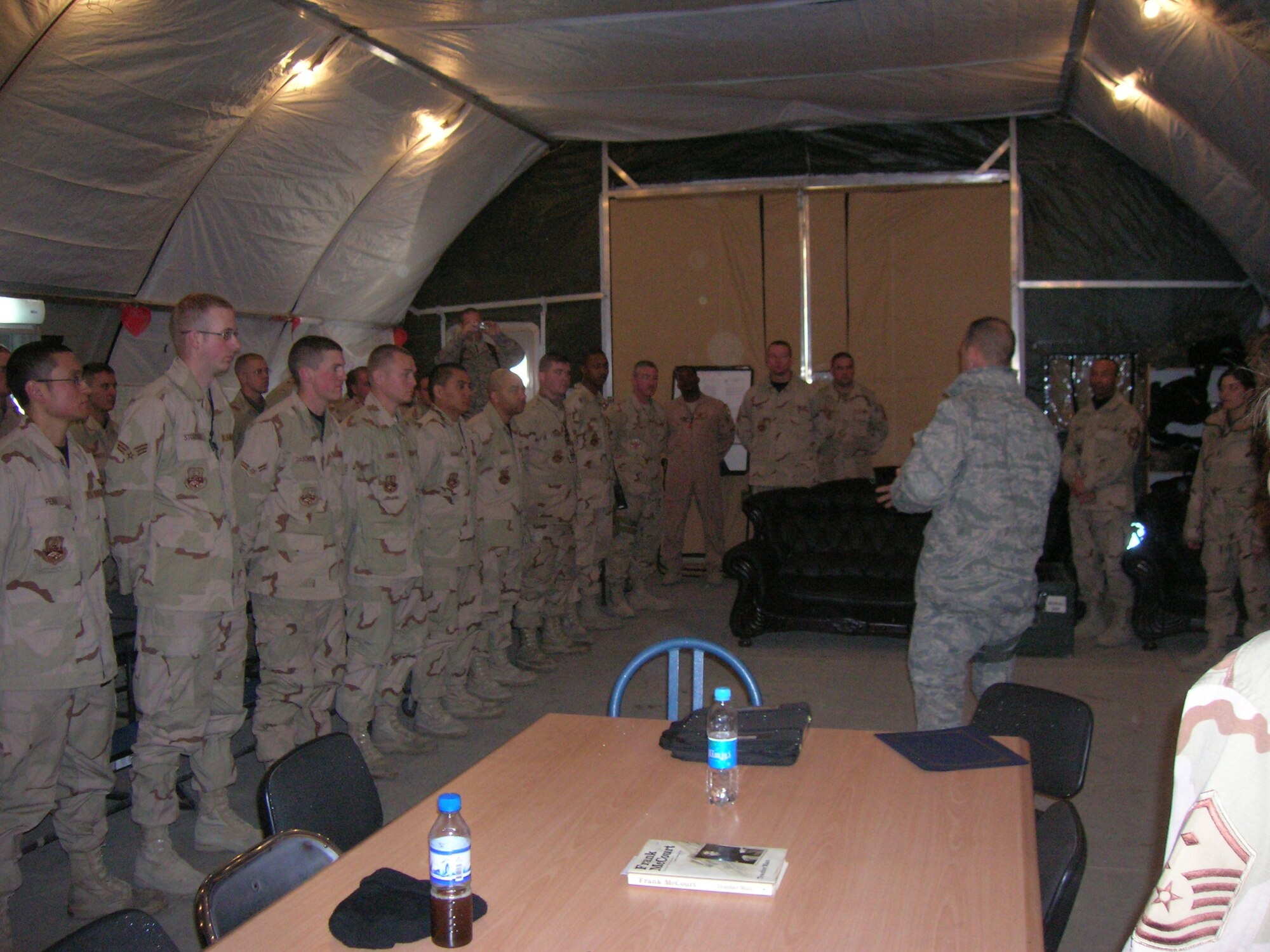 BAGRAM AIR BASE, Afghanistan -- Col. Jon Sutterfield, 455th Expeditionary Maintenance Group commander, talks to members of the 455th Expeditionary Aircraft Maintenance Unit, about their performance during the last month. Four deployed Airman from Spangdahlem Air Base, Germany, were recognized as base award winners during January. (U.S. Air Force photo/1st Lt. Nicholas Bosiak)