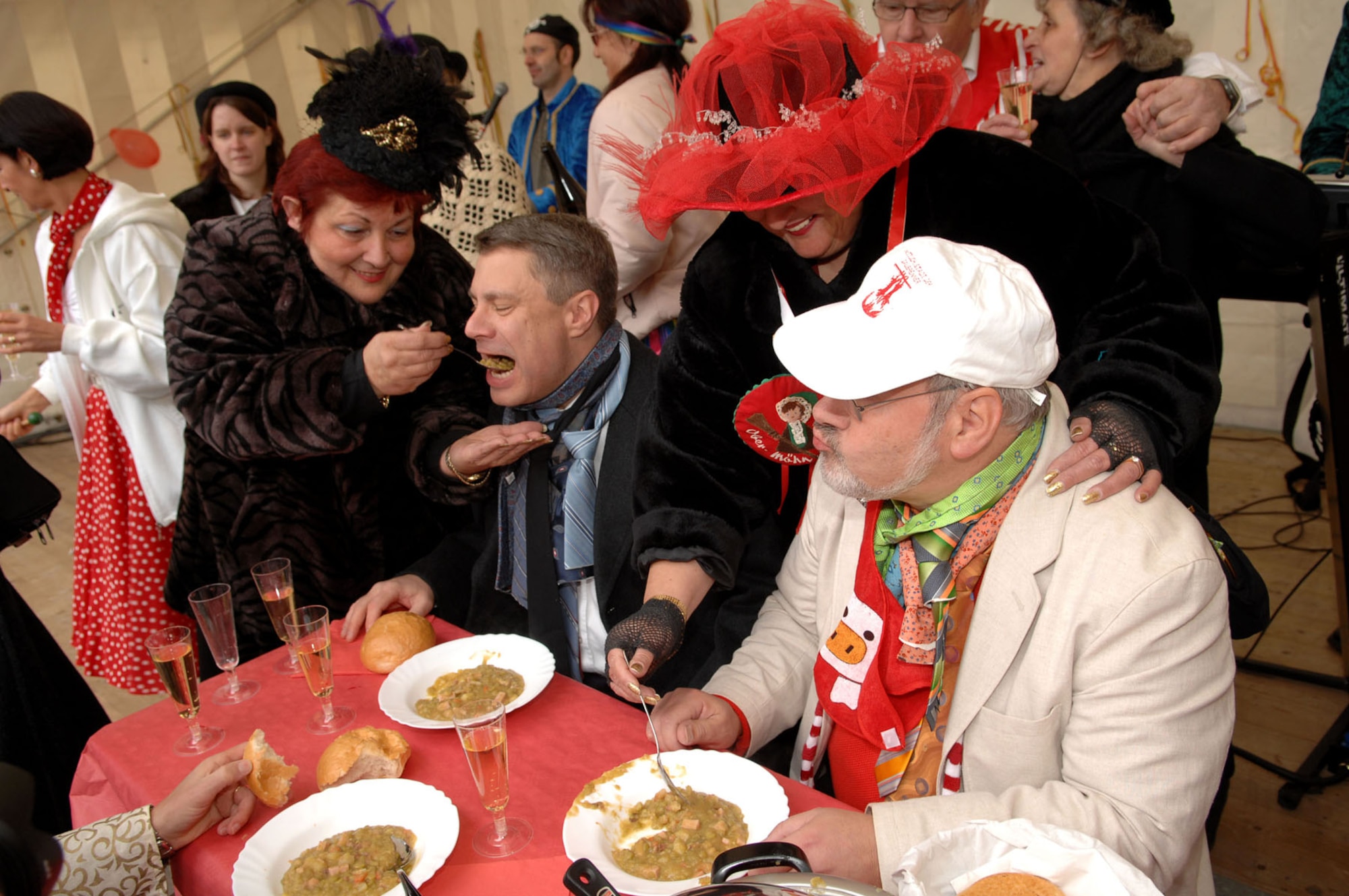 SPANGDAHLEM AIR BASE, Germany -- Following the festivities of Weiberdonnerstag (Women’s Thursday) Lt. Col. Kevin Bennett, 52nd Communications Squadron commander, and the honorary Mayor of Wittlich, is spoon-fed ham and bean stew alongside Albert Klein, deputy Burgermeister, Jan. 31, 2008. (U.S. Air Force photo/Senior Airman Matthew S. Bright)  