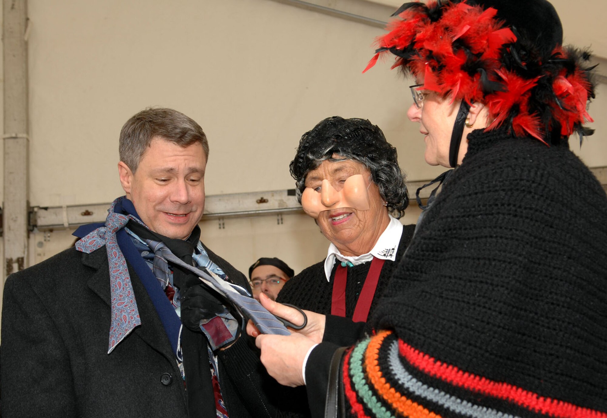 SPANGDAHLEM AIR BASE, Germany -- Lt. Col. Kevin Bennett, 52nd Communications Squadron commander, and the honorary Mayor of Wittlich, has one of his ties cut by a Wittlich matron during the Weiberdonnerstag (Women’s Thursday) festival, Jan. 31, 2008. In accordance with tradition, women cut the ties of men taken captive during the Weiberdonnerstag party, taking away their power for the day. (U.S. Air Force photo/Senior Airman Matthew S. Bright)