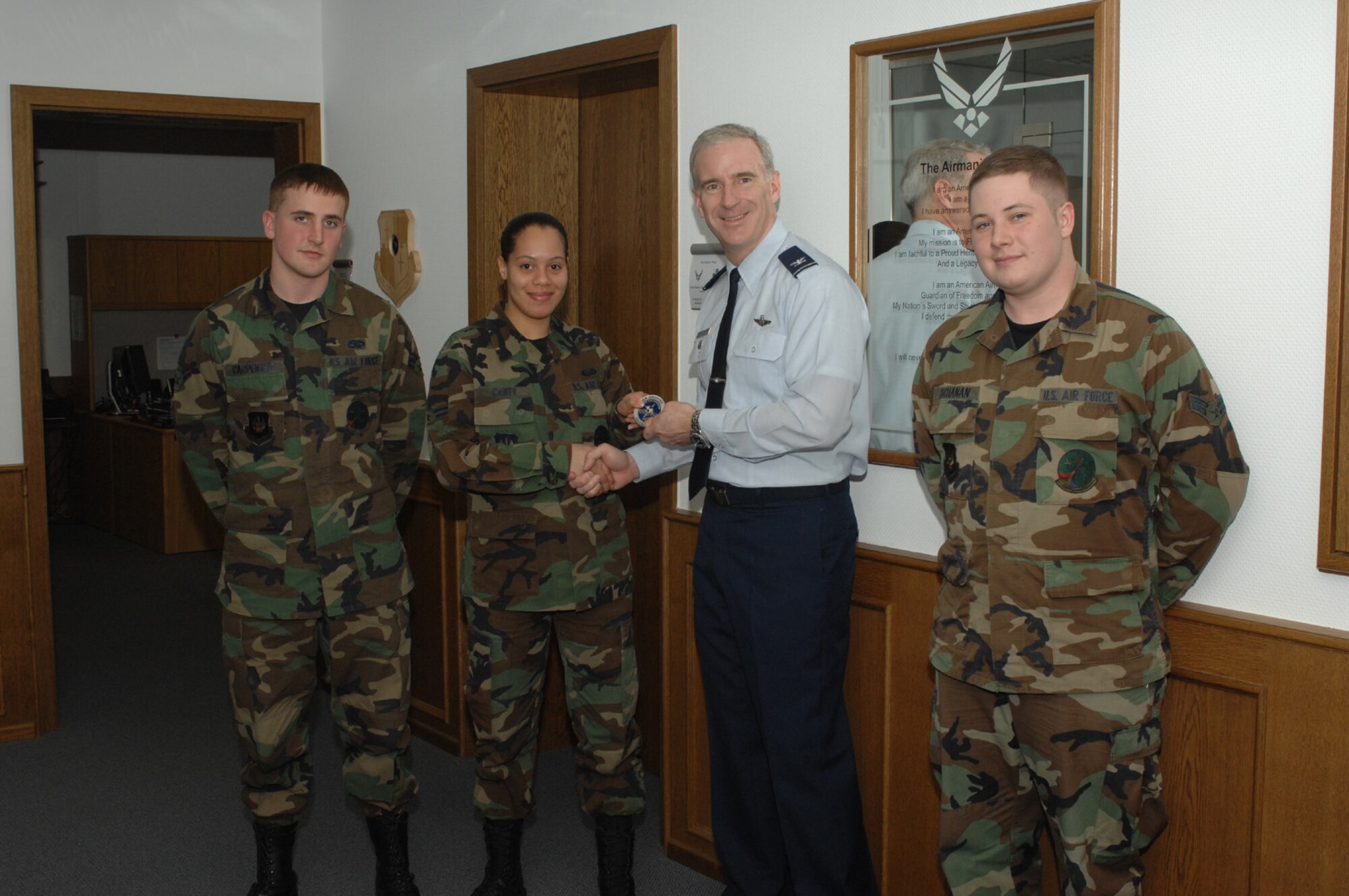 SPANGDAHLEM AIR BASE, Germany – Col. Thomas Feldhausen, 52nd Fighter Wing vice commander, returns the 52nd Equipment Maintenance Squadron Saber Choices coin to 52nd EMS Airmen. The coin signifies that the unit has gone 52 days without any driving while under the influence or alcohol related incidents. (U.S. Air Force photo/Senior Airman Kristen Ruleau)