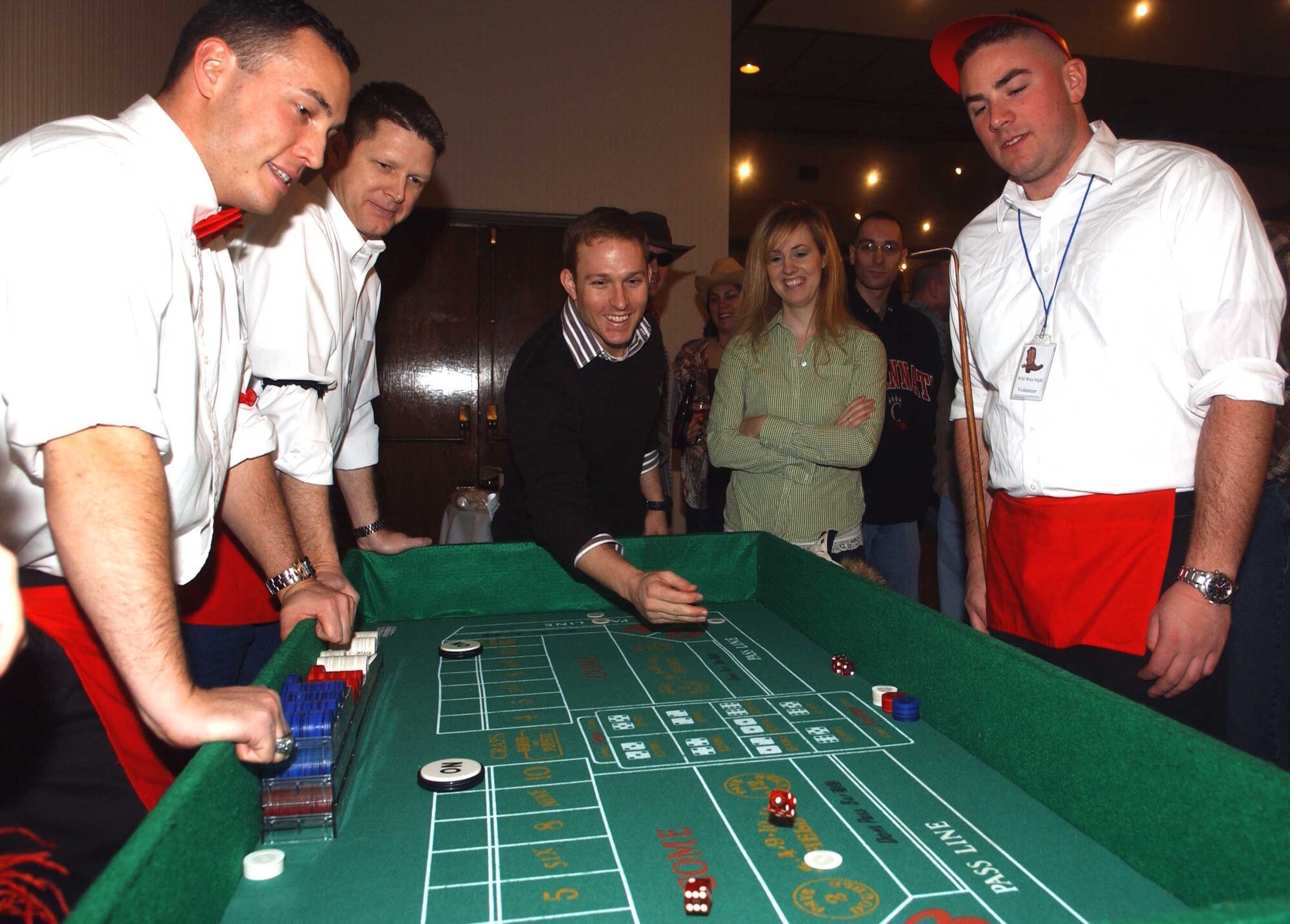 OSAN AIR BASE, Republic of Korea -- A Wild West Night participant tries his luck at the craps table Feb. 2 at the officers' club. More than 200 members of Team Osan took part in the Western-themed annual fundraiser, first started in 1980, and sponsored by the Osan Officers Spouses' Club. (U.S. Air Force photo/Tech. Sgt. Matt Summers)