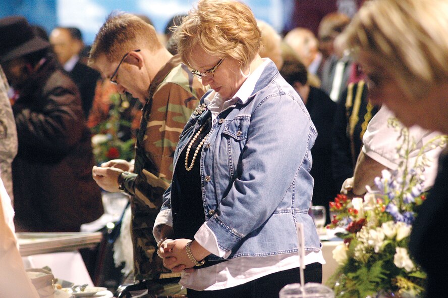 Liz McCarthy bows in prayer at the national  prayer luncheon Jan. 29. Guest speaker, Chaplain (Brigadier General) Cecil R. Richardson, Air Force deputy chief of chaplains, spoke on the theme "In God We Trust" and special music was provided by the Judy Martin Hess band. U. S. Air Force photo by Sue Sapp