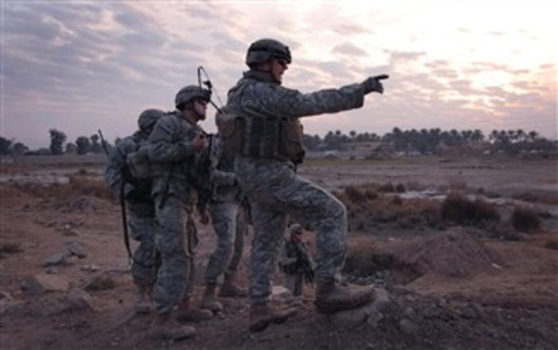 U.S. Army Capt. Will Canda points out a possible route to follow while attempting to navigate his convoy through a muddy field in Baghdad’s Sha’ab neighborhood Jan. 27, 2008. Canda is a 325th Airborne Infantry Regiment, 82nd Airborne Division commander. 