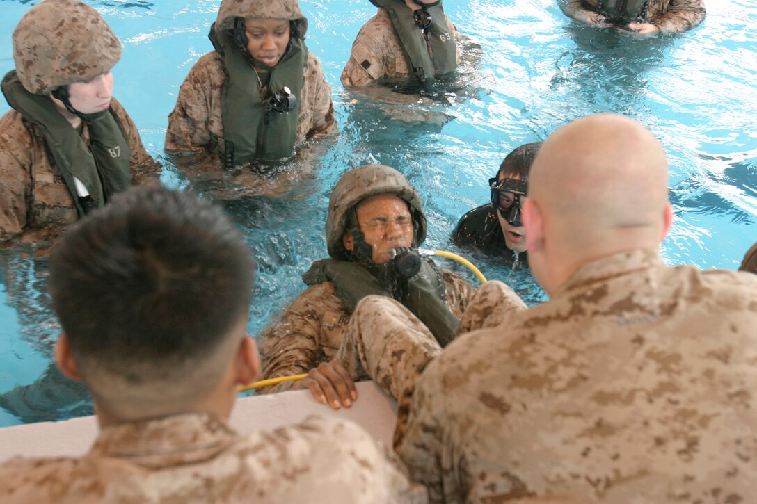CAMP LEJEUNE, N.C. (Feb. 7, 2008) ? Petty Officer 1st Class Myesha S. Booker, religious program specialist with the 26th MEU Command Element, emerges from an upside-down position while training on the proper use of an air regulator.  Marines and Sailors of the 26th MEU participated in SWET aboard Camp Lejeune, N.C., Feb. 6-7, 2008. The exercise taught the Marines to escape a downed helicopter under water. (Official USMC photo by Gunnery Sgt. Clark Schindler) (Released)