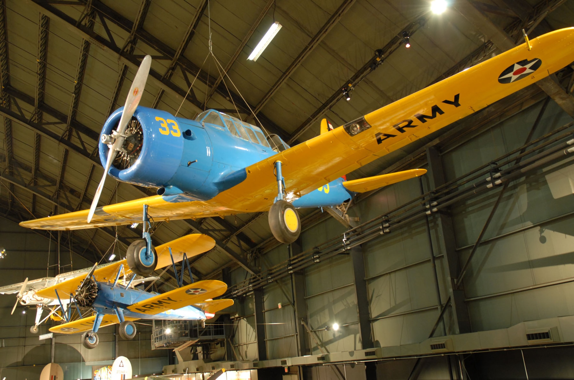 DAYTON, Ohio -- Vultee BT-13B Valiant (foreground) and Stearman PT-13D Kaydet in the World War II Gallery at the National Museum of the United States Air Force. (U.S. Air Force photo)