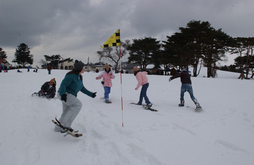 MISAWA AIR BASE, Japan -- Members of the Misawa Air Base community compete in a snow shoe race on the Golf Course during Winterfest on Feb. 3, 2008. The Winterfest also featured a snowman building contest, a home-made sled contest, cross-crountry skiing and sledding. (U.S. Air Force photo by Senior Airman Robert Barnett)