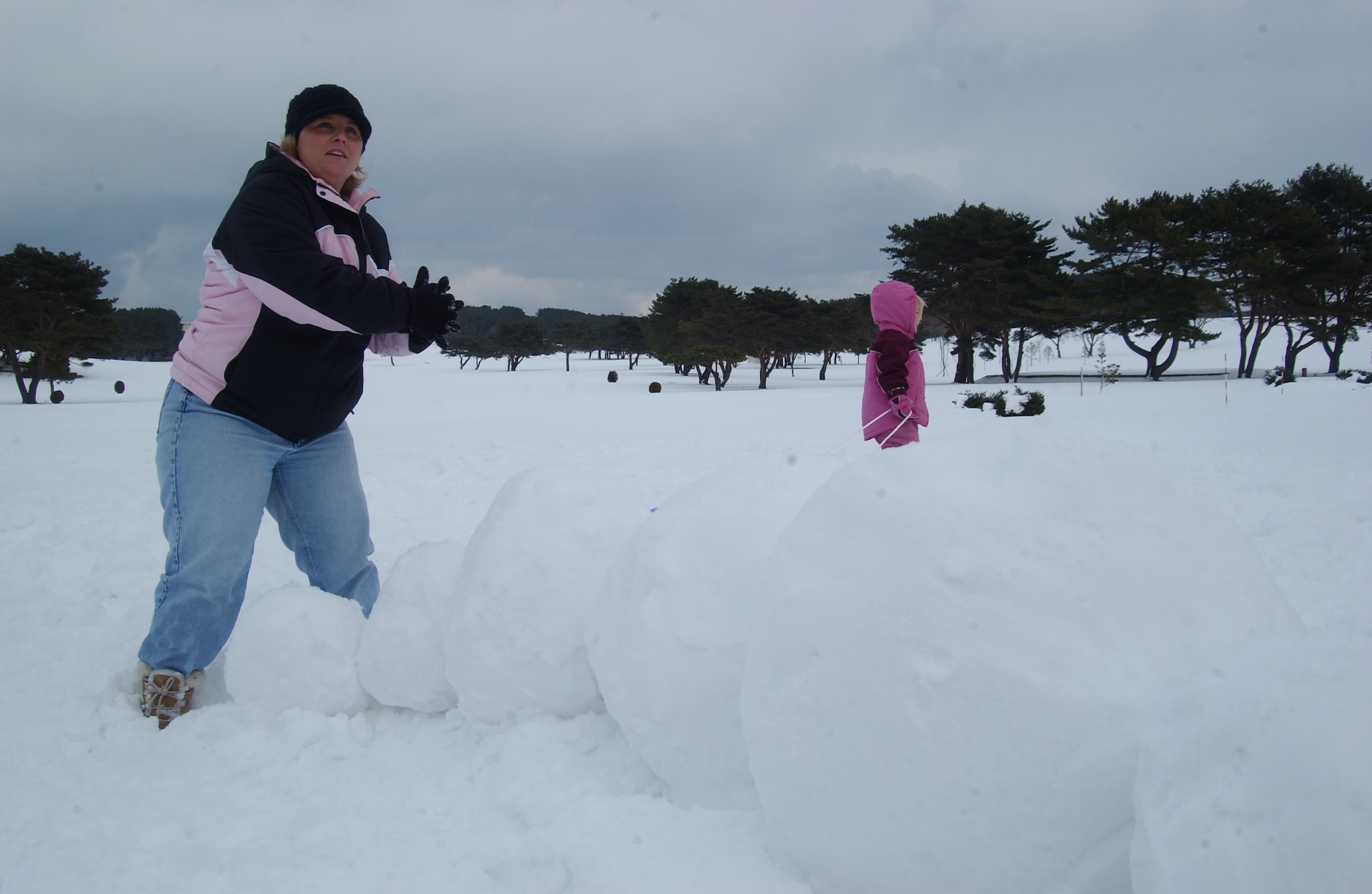 MISAWA AIR BASE, Japan -- Edie Lindgren works on building a snow caterpillar on the Golf Course during Winterfest on Feb. 3, 2008. The Winterfest was part of the 35th Services Squadron Customer Appreciation Week. (U.S. Air Force photo by Senior Airman Robert Barnett)