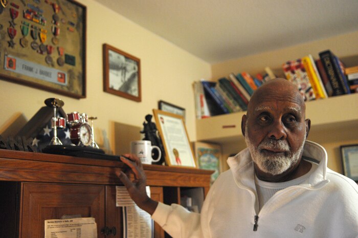 LAS VEGAS—Retired Army Master Sgt. Frank Barbee stands next to memorabilia displaying his long heritage of service to the Armed Forces in his home here Feb. 4. Barbee, 87, spent 40 years in the Army and now volunteers his time at the Nellis AFB Commissary. (U.S. Air Force photo by Senior Airman Nadine Y. Barclay)