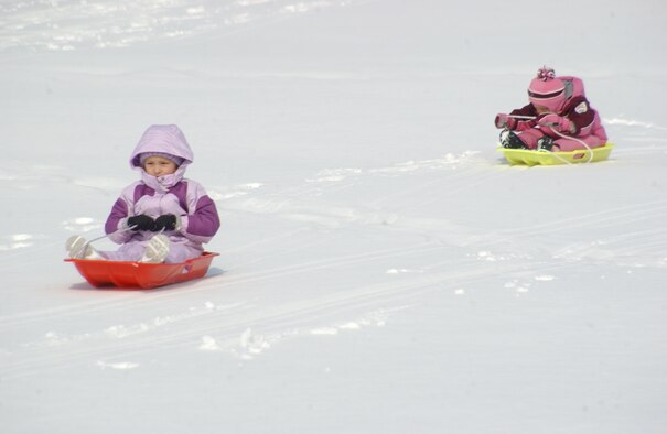 MISAWA AIR BASE, Japan -- Ella Shaw leads the way as she and friend Teagen Lindgren, both 4 years old, sled on the Golf Course during a Winterfest Feb. 3, 2008. The Winterfest kicked of the 35th Services Squadron Customer Appreciation Week. (U.S. Air Force photo by Senior Airman Robert Barnett)