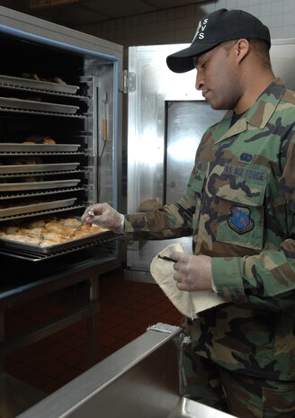 NELLIS AIR FORCE BASE, Nev.—Airman 1st Class Curtis Wright, 99th Services Squadron, checks the temperature of baked chicken in preparation for the lunch rush at the Crosswinds Dining Facility here Feb. 6. The 99th SVS captured the 2008 Air Combat Command General Curtis E. LeMay Services Award here Jan. 25. This marks the third time in fours years the 99th SVS has won the award. (U.S. Air Force photo by Staff Sgt. Scottie T. McCord)