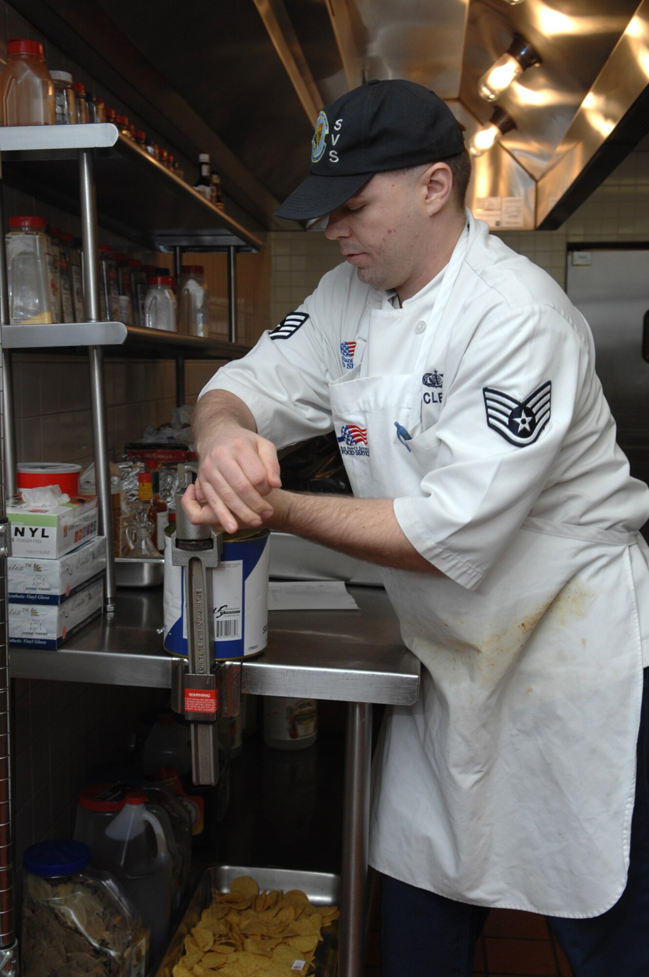 NELLIS AIR FORCE BASE, Nev.—Staff Sgt. Sean McCleallan, 99th Services Squadron, opens a can of yams in preparation for the lunch rush at the Crosswinds Dining Facility here Feb. 6. The 99th SVS captured the 2008 Air Combat Command General Curtis E. LeMay Services Award here Jan. 25. This marks the third time in fours years the 99th SVS has won the award. (U.S. Air Force photo by Senior Airman Nadine Y. Barclay)