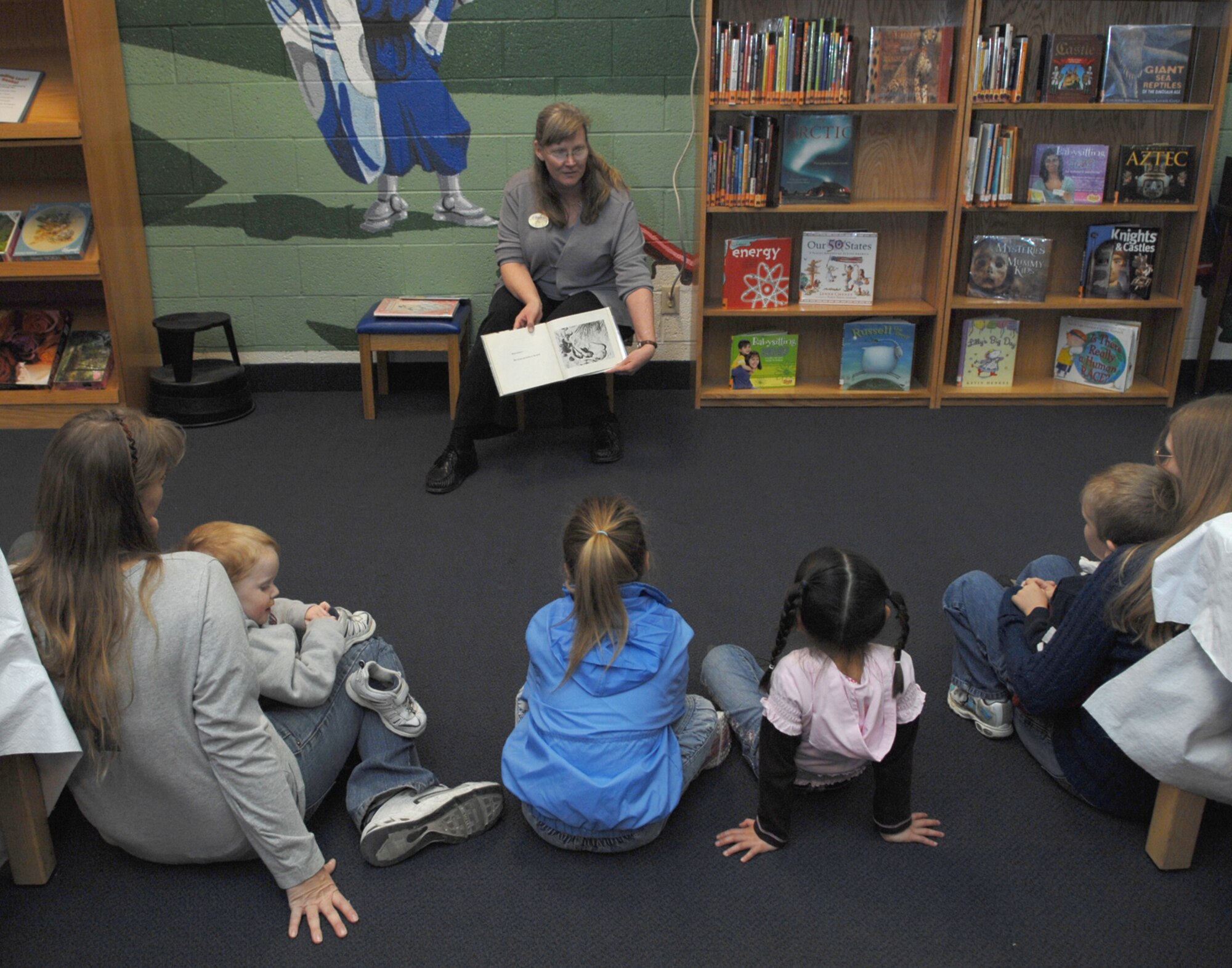 NELLIS AIR FORCE BASE, Nev.—Jo Davis, 99th Services Squadron library director, reads to children during story time here Feb. 6. The 99th SVS captured the 2008 Air Combat Command General Curtis E. LeMay Services Award here Jan. 25. This marks the third time in fours years the 99th SVS has won the award. (U.S. Air Force photo by Senior Airman Nadine Y. Barclay)