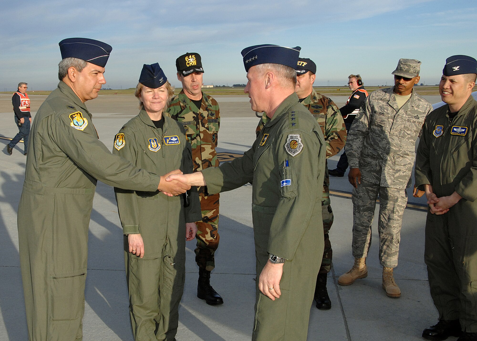 TRAVIS AIR FORCE BASE, Calif. -- Colonel Abel Barrientes, Vice Commander of the 349th Air Mobility Wing greets General Bruce Carlson, Commander, Air Force Materiel Command, upon arrival at Travis AFB, CA.  Colonel Maryanne Miller, Commander of the 349th Air Mobility Wing, is pictured in the background. General Carlson was at Travis to visit Air Force Materiel Command-related assets and missions located at Travis
(US Air Force Photo by David W. Cushman) (Released)