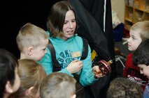 MINOT AIR FORCE BASE, N.D. – Rachel Filkins, the assistant director of Outdoor Recreation, shows group of eager young children the fish she “caught” in an ice at the Child Development Center here Feb. 6.  The ice fishing exhibit was a learning activity that was part of the CDC’s Winter Fest. (U.S. Air Force photo by Staff Sgt. Thomas Dow)