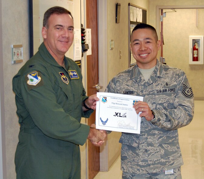 LAUGHLIN AIR FORCE BASE, Texas -- Tech Sgt. Howard Santos, 47th Aero Medical Dental Squadron recieves the Laughlin's XLer award from Col. John Doucette, 47th Flying Training Commander, Feb. 5. (U.S. Air Force photo by Senior Airman Olufemi Owolabi)