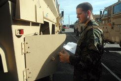 Senior Airman Nicholas Sansone, 437th Aerial Port Squadron special handling section, performs a joint inspection with Dyncorp personnel on a mine resistant ambush protected vehicle.  The inspection is performed to ensure an MRAP is ready to be loaded on to an aircraft. (U.S. Air Force photo/Staff Sgt. Jennifer Arredondo)