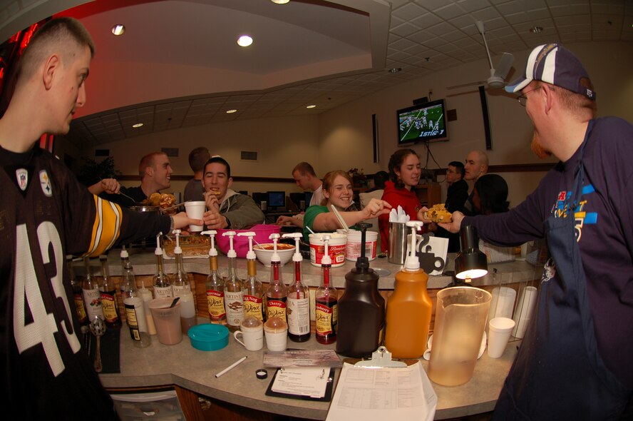 Airmen and volunteers enjoy non-alcoholic beverages and watch the Super Bowl at the Eagle’s Net Internet Café located in Dorm 435. (U.S. Air Force Photo/Airman 1st Class Shen-Chia Chu)