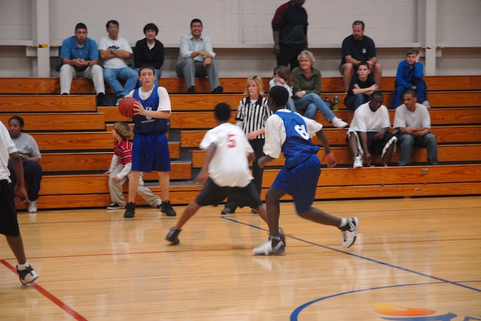 Joey Marlowe of the Charleston AFB Mavericks looks to see where he will make a pass during a youth basket ball game, Feb. 4 at the Sports and Fitness Center here. (U.S. Air Force photo/Staff Sgt. Jennifer Arredondo)