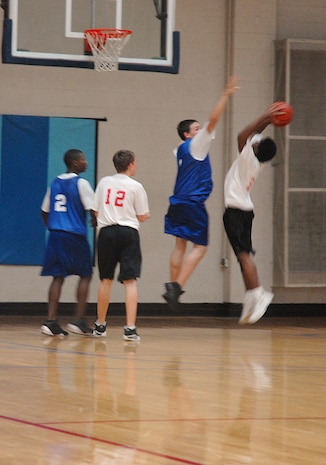 Joey Marlowe, 14,  of the Charleston AFB Mavericks basketball team, tries to block a Moncks Corner Bulls player from making a basket during a basketball game at the Sports and Fitness Club here Feb. 4. (U.S. Air Force photo/Staff Sgt. Jennifer Arredondo)