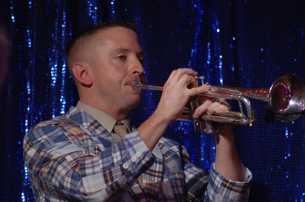 SEDALIA, Mo. – Tech. Sgt. Joseph Diaz, a Tops in Blue musician, plays the trumpet during the musical tribute “The Fly-By” at the Mathewson Exhibition Center at the Missouri State Fairgrounds Jan. 31. (U.S. Air Force photo/Airman 1st Class Stephen Linch)