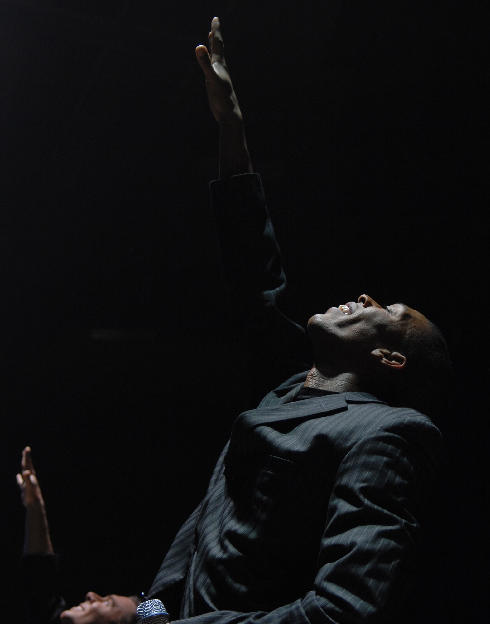 SEDALIA, Mo. – Senior Airman Tyrece Robertson, a Tops in Blue vocalist, performs during the musical tribute “The Fly-By” at the Mathewson Exhibition Center at the Missouri State Fairgrounds Jan. 31. (U.S. Air Force photo/Airman 1st Class Stephen Linch)