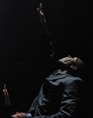 SEDALIA, Mo. – Senior Airman Tyrece Robertson, a Tops in Blue vocalist, performs during the musical tribute “The Fly-By” at the Mathewson Exhibition Center at the Missouri State Fairgrounds Jan. 31. (U.S. Air Force photo/Airman 1st Class Stephen Linch)