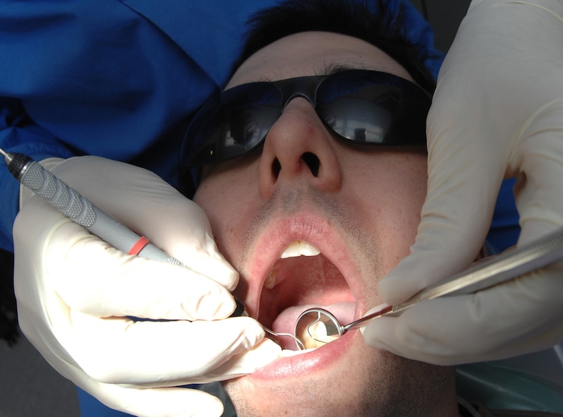 DYESS AIR FORCE BASE, Texas -- Lt. Col. Randall Griffin looks for cavities in Airman 1st Class Ben Hayes mouth Feb. 5. (U.S. Air Force Photo by Airman 1st Class Jennifer Romig)