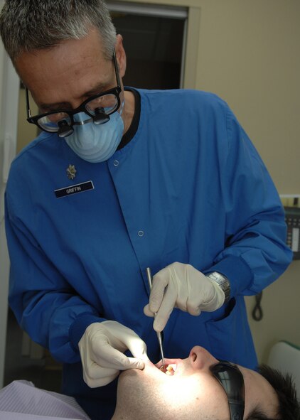 DYESS AIR FORCE BASE, Texas -- Lt. Col. Randall Griffin looks for cavities in Airman 1st Class Ben Hayes mouth Feb. 5. (U.S. Air Force Photo by Airman 1st Class Jennifer Romig)