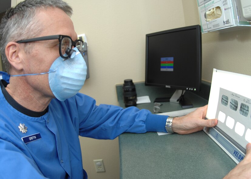 DYESS AIR FORCE BASE, Texas -- Lt. Col. Randall Griffin goes over Airman 1st Class Ben Hayes dental records Feb. 5. (U.S. Air Force Photo by Airman 1st Class Jennifer Romig)