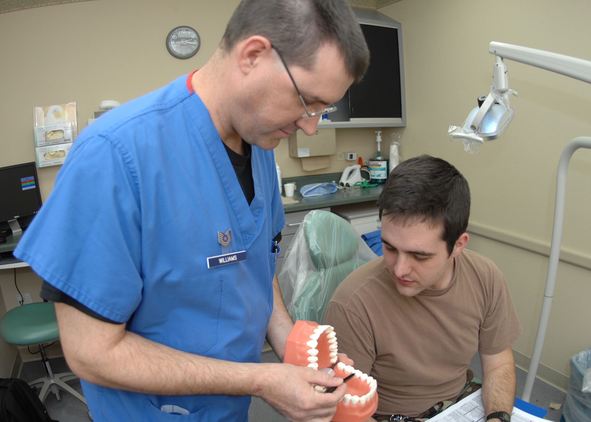 DYESS AIR FORCE BASE, Texas -- Technical Sgt. Jack Williams goes over dental care with Airman 1st Class Ben Hayes Feb. 5. (U.S. Air Force Photo by Airman 1st Class Jennifer Romig)