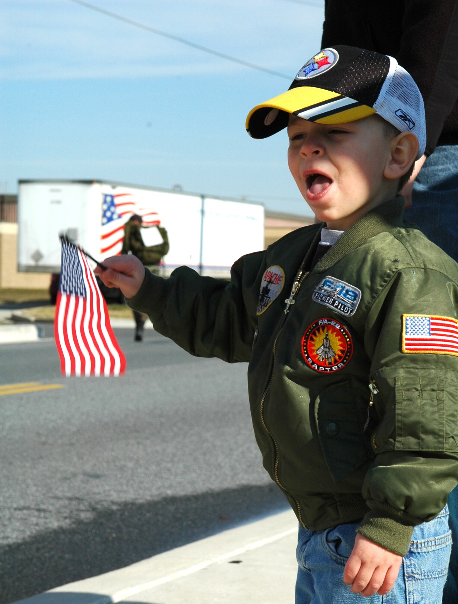 Trestin Nicely, son of Staff Sgt. Brandon Nicely, 436th Mission Support Squadron personnelist, cheers for participants of the 9th Annual Ruck March, Feb. 2 at the Air Mobility Museum here. Members of the Army, Marine Corps, and civilian sector joined Airmen in commemorating Veterans of the Korean War Battle of Chosin Reservoir. (U.S. Air Force photo/Senior Airman Andria J. Allmond) 