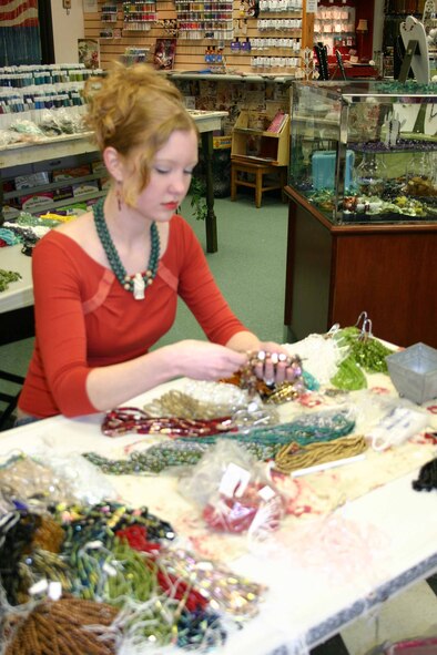 Bead designer Kacey Walkingstick sorts through new beads to add to the selection available at Alouette Bead Design Center in the Services Mall, Bldg. 478.  (Air Force photo by Jennifer D’Alessandro)