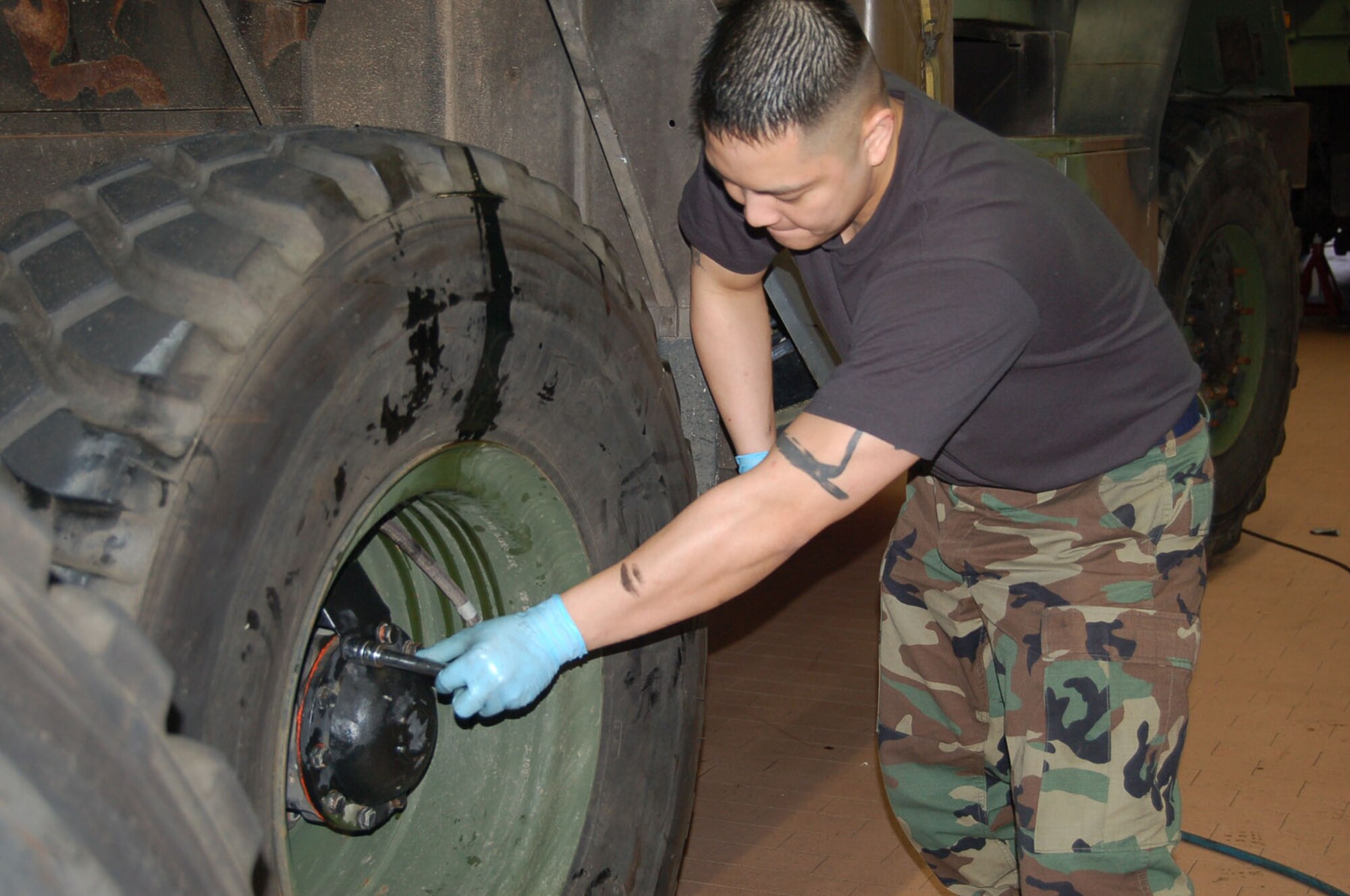 SPANGDAHLEM AIR BASE, Germany – Staff Sgt. Carlo Aquino, 606th Air Control Squadron, does a wheel bearing repack. The 606th ACS vehicle maintainers perform wheel bearing repacks annually. (Photo by Sequoia Montgomery)